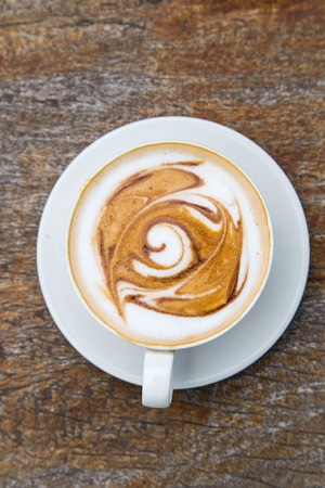 art latte coffee on white cupの写真素材