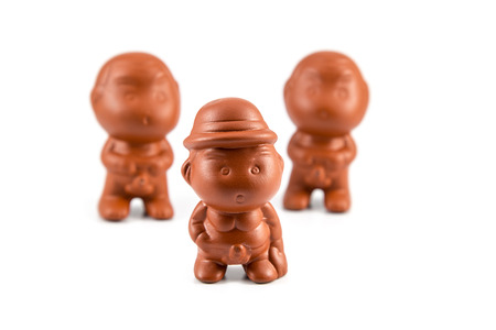 Clay dolls boy peeing isolated on white background.の写真素材