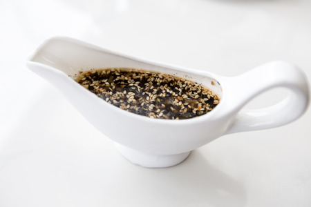 Black sesame delicious salad dressing in a nice platterの写真素材