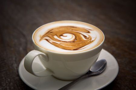 art latte coffee on white cupの写真素材
