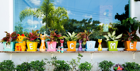 The colorful welcome sign on pot