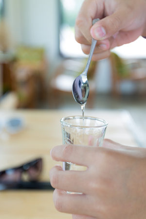 syrup in glass bottle on wood backgroundの写真素材