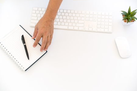 White workspace with keyboard and notebookの写真素材