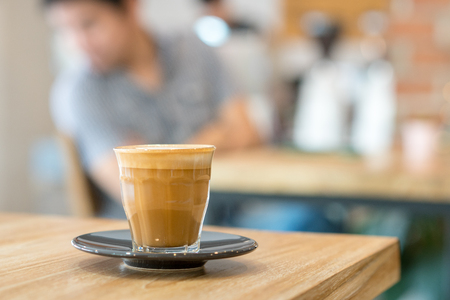 Hot Latte art coffee cup on wooden tableの写真素材