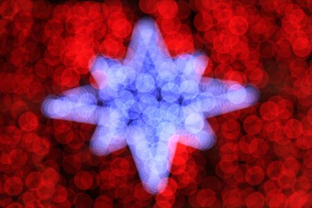 Out of focus christmas decoration on the street at nightの写真素材