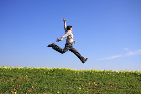 Young man jumping in a beautiful landscape