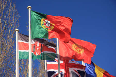 Country flags - Portugal, kenya, and Great-Britain- isolated on a blue skyの写真素材