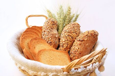 Assortment of baked bread with wheat isolated on white background