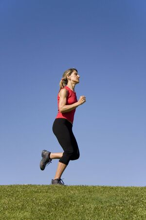 Sporty young woman running on the natureの写真素材