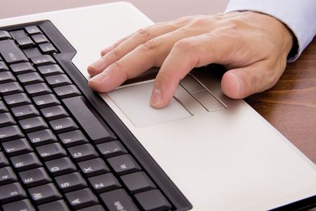 Male hand typing on a laptopの写真素材