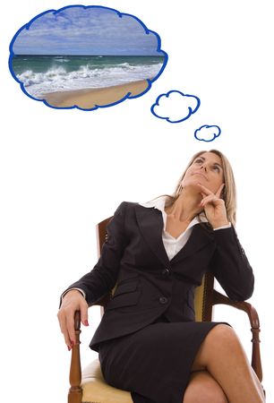 Beautiful young woman looking up dreaming about vacationsの写真素材