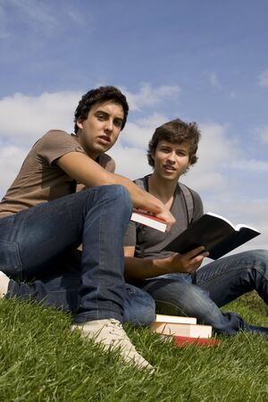 Two college or university students studying on the park