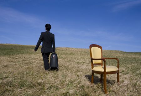 Man holding a big travelling bag going away aloneの写真素材