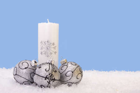Xmas candles with three shiny baublesの写真素材