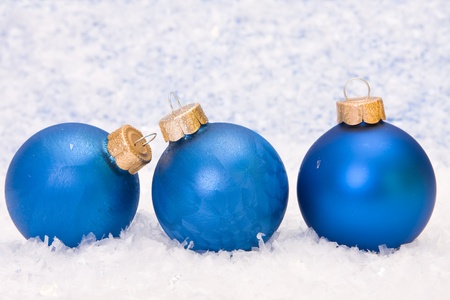 Three blue baubles on the snowの写真素材