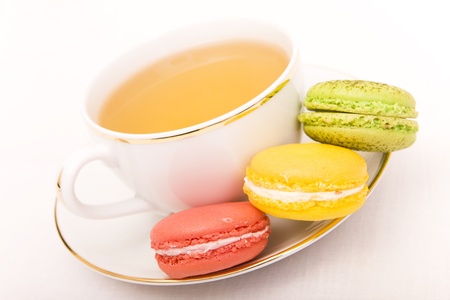 Cup of tea with three colorful macaronsの写真素材