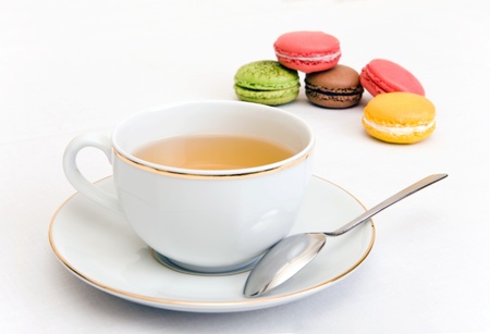 Cup of tea with colorful french macaronの写真素材