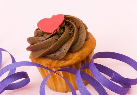 Special chocolate cupcake with a red heart shape on the topの写真素材