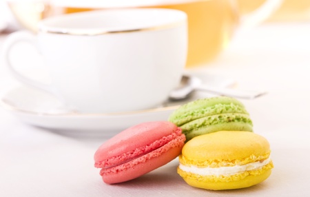 Colorful macaron with a cup of tea - Focus on the yellow oneの写真素材
