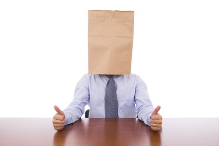 Strange business man with a cardboard bag on the head showing thumbs upの写真素材