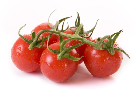 Close up of fresh red tomatoes on a white backgroundの写真素材