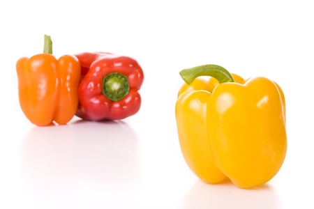 red, orange and yellow pepper isolated on whiteの写真素材