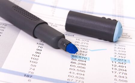 Blue marker and a report sheet with numbers underlinedの写真素材