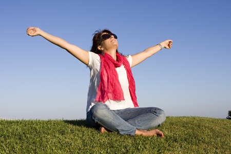 Beautiful woman enjoying life with her arms outstretchedの写真素材
