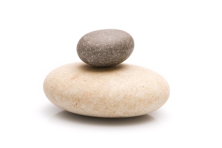 White and Black - Two stones symbolizing the harmony on a white backgroundの写真素材