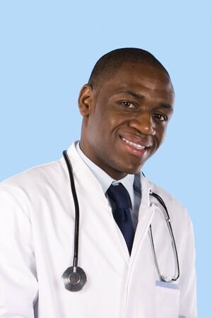 Portrait of an happy young doctor on a blue backgroundの写真素材
