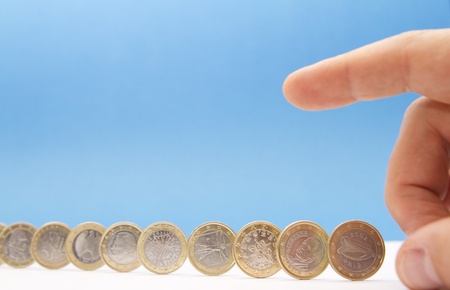 Concept about the european monetary crisis - Hand ready to cause a chain reactionの写真素材