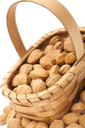 Unshelled almonds in a basketの写真素材