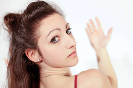 Young pretty teenage girl brunette in studio with long hair