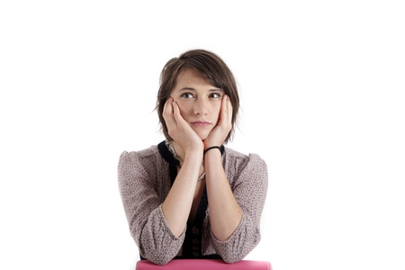 young woman looking ahead with hand under her face isolated in studio