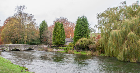 A house by the flooded river in autumnの写真素材
