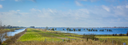 Flooded farmland in Norfolk UK on a bright day in Winterの写真素材