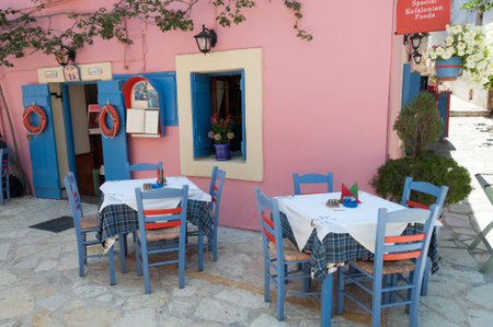 Resultant in a seaside village in Greece on a lovely summers day with a view into the villageの写真素材
