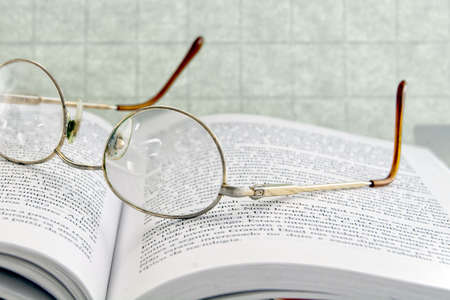 Nice eyeglasses on top of an open bookの写真素材