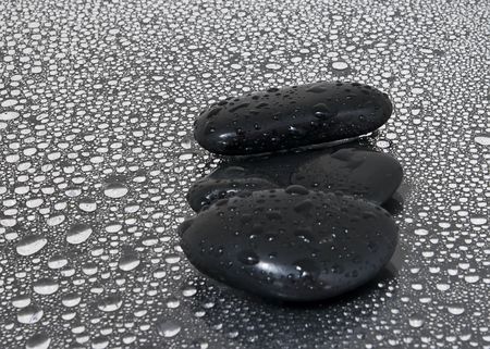 Black stones with water dropsの写真素材