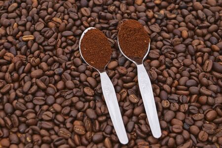 Coffee grains with two spoon with coffeeの写真素材