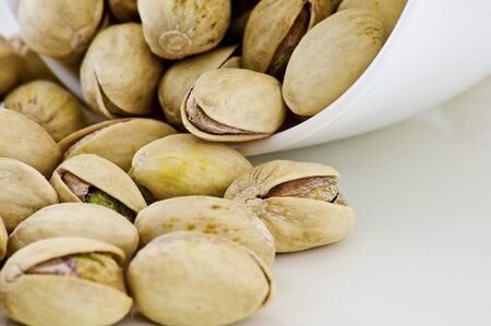 Salted pistachios isolated on white background 