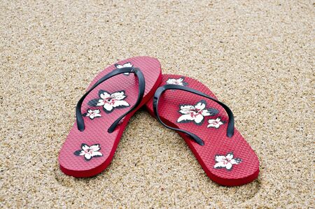 Flipflops on the sand with great colors and amazing lightの写真素材