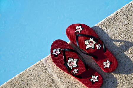 Flip-flops by the pool with great light and amazing colorsの写真素材