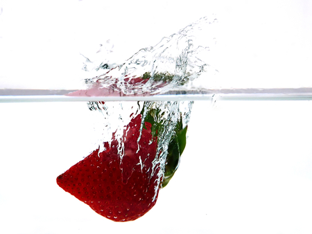 Strawberry splash in white backgroundの写真素材