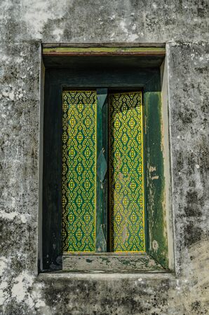 Traditional Thai style Buddhist church window, Thailandの写真素材