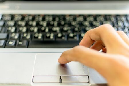 hand working on a laptop touchpadの写真素材