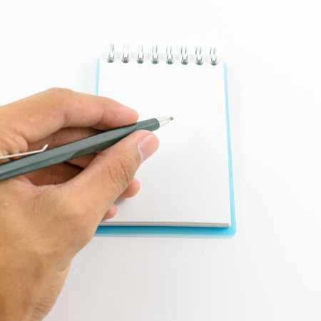 Writing notes or planning a schedule on blank spiral notebook for copyの写真素材