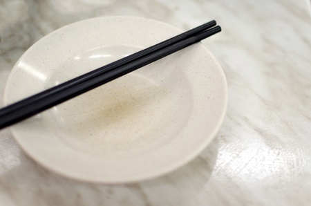 Empty white plate with chopsticks の写真素材