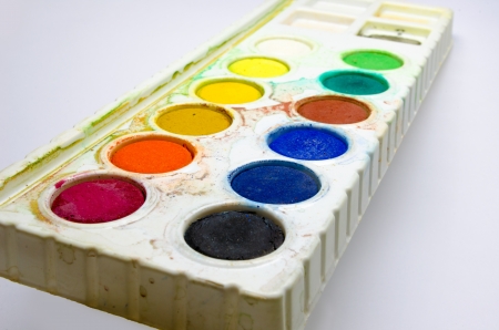 a dirty water color palette isolated on white backgroundの写真素材