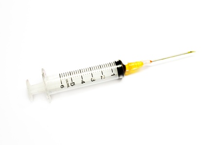 syringe with yellow ink to the printer. isolated on white background.の写真素材